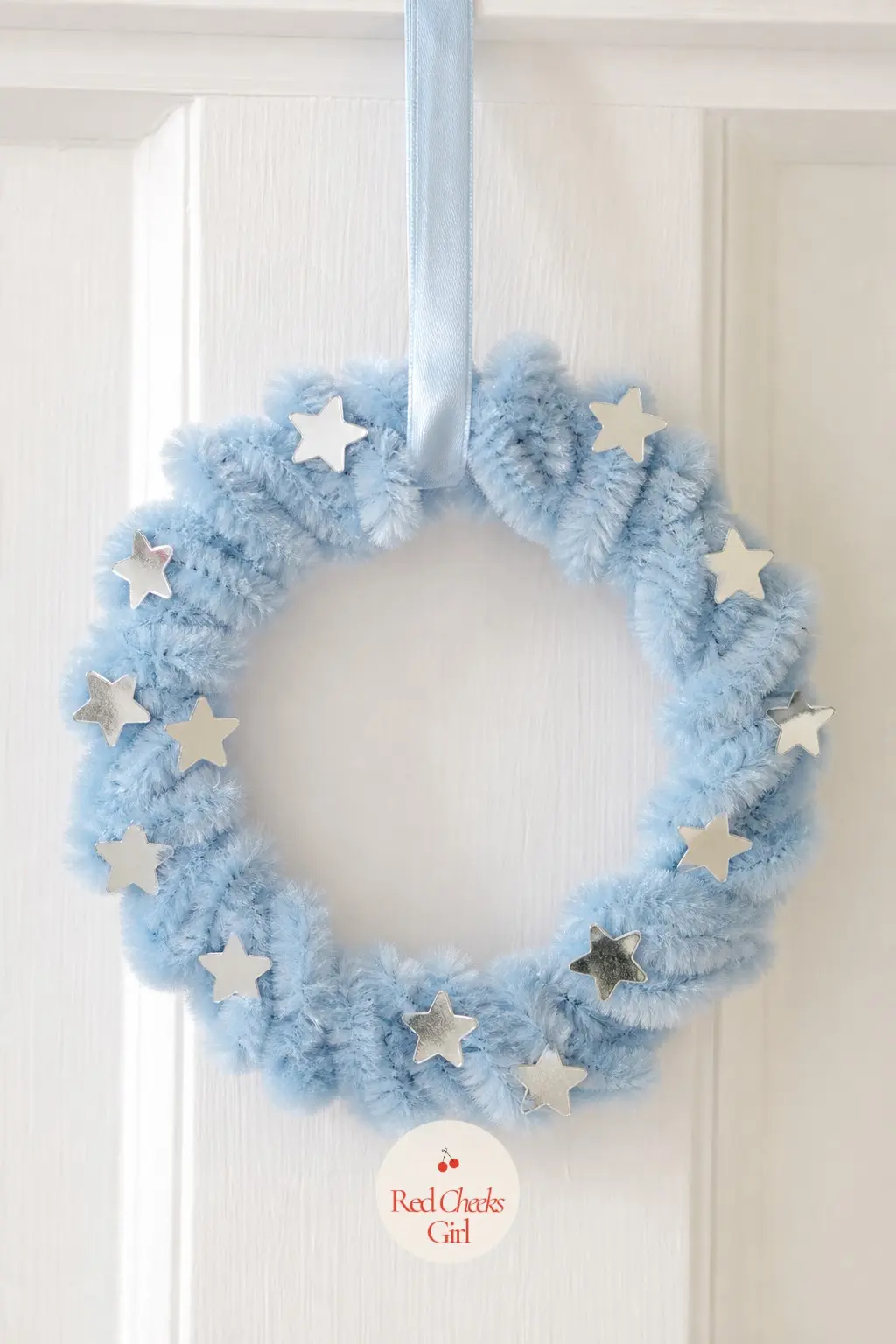 The Baby Blue and Silver Star Bead Wreath for the Nursery Door — Pale baby blue pipe cleaners coil the base while small silver star-shaped sequins get threaded