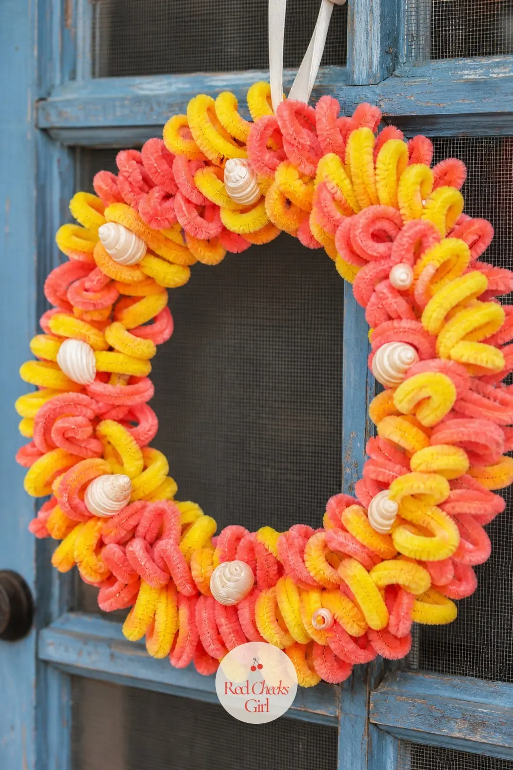 The Coral and Sunshine Coil Door Wreath for the Pool Party — Bright coral and sunshine yellow stems wrap a lightweight wire frame for a wreath that reads as