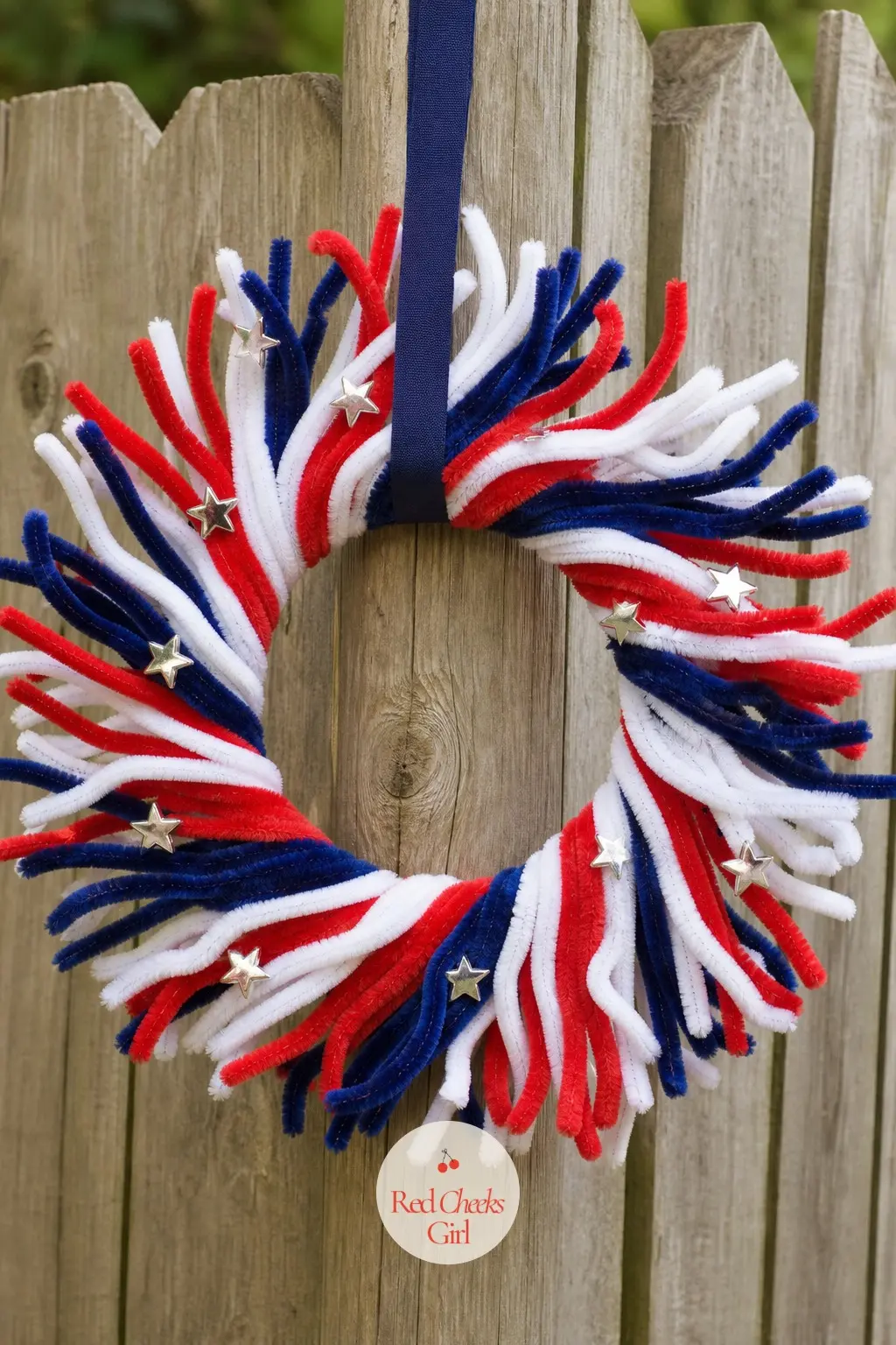 The Red White and Blue Starburst Wreath for the Backyard Cookout — Three colors in even thirds around the frame keep this one from reading as a Christmas