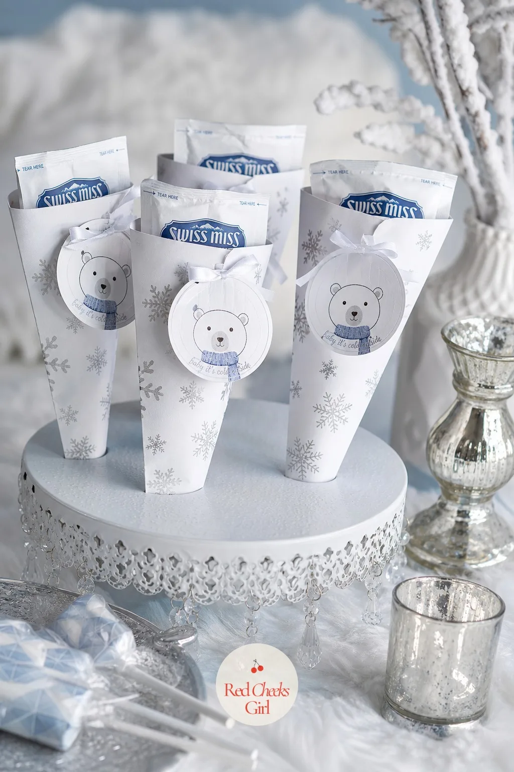 Mini Hot Cocoa Favor Cones with Bear Tags — A paper cone, white with a silver snowflake print, holds a single-serve packet of hot cocoa and a handful of mini