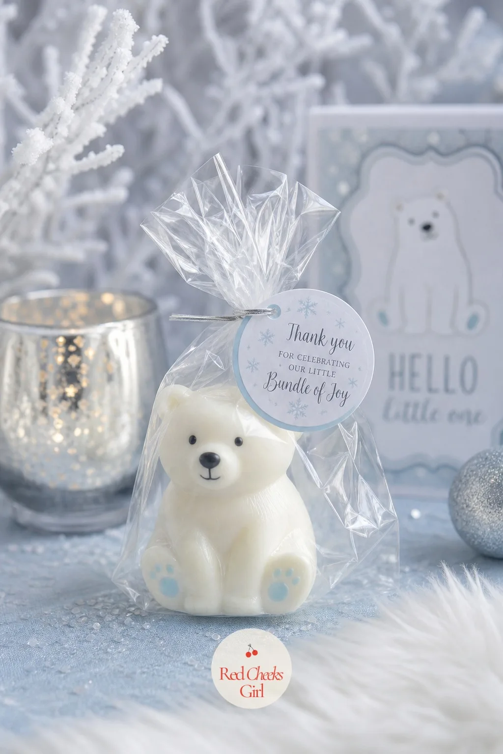 Polar Bear Soap Favors — A small bar of glycerin soap, molded in the shape of a sitting polar bear and tinted the faintest icy blue at the base, sits wrapped