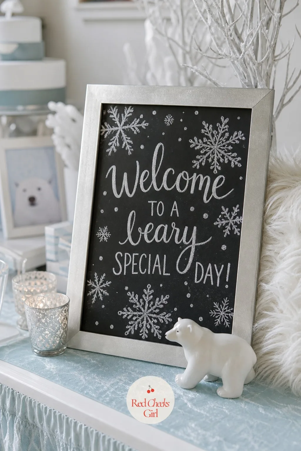 Snowflake Chalkboard Welcome Sign — A chalkboard in a plain silver frame, snowflakes drawn loose around the border in white chalk pen, keeps the entrance from