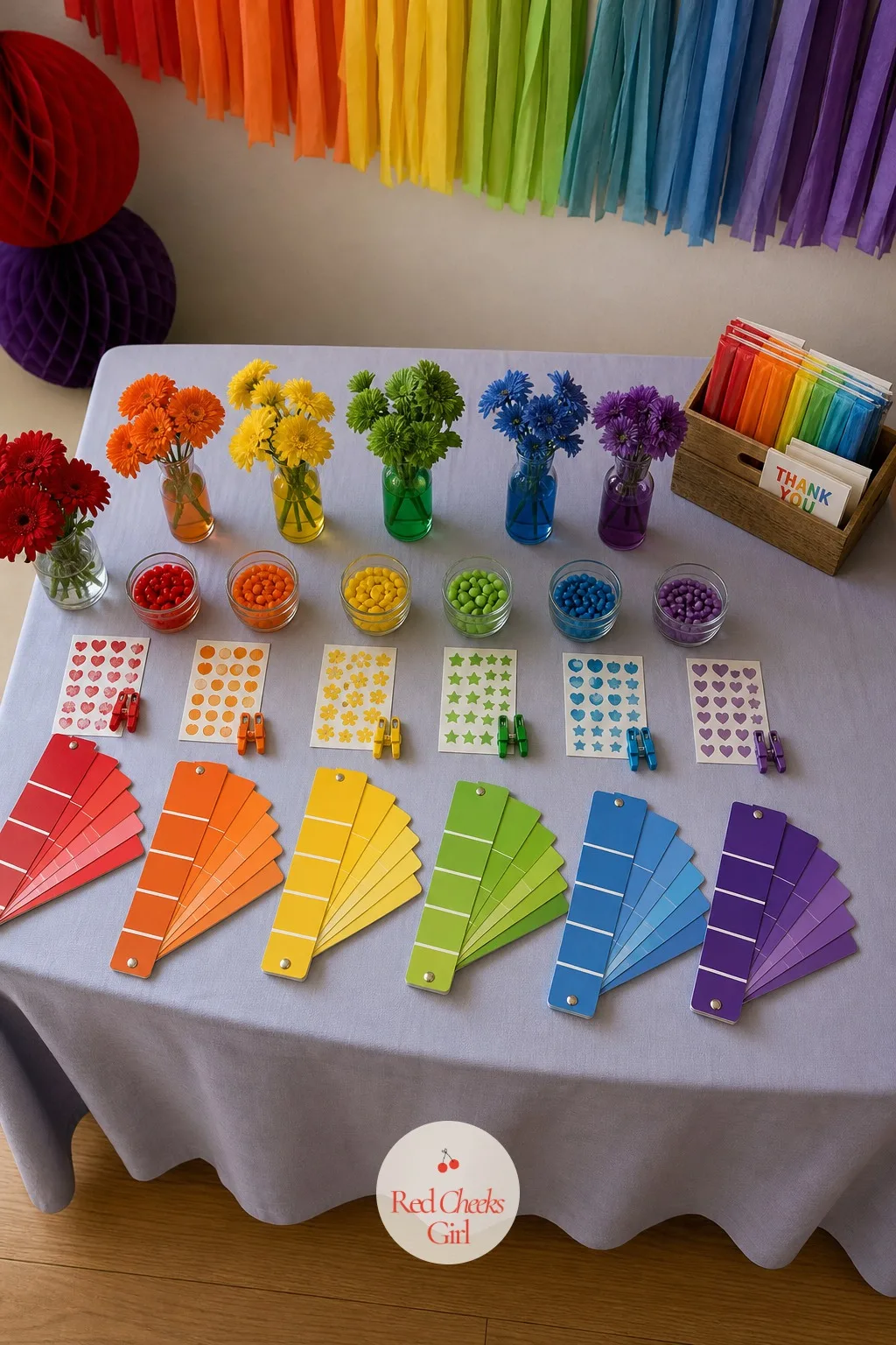A Favor Table Fanned With Color Swatch Paddles — A candy-only favor bag usually gets left behind in the car by a parent who has heard enough about sugar for