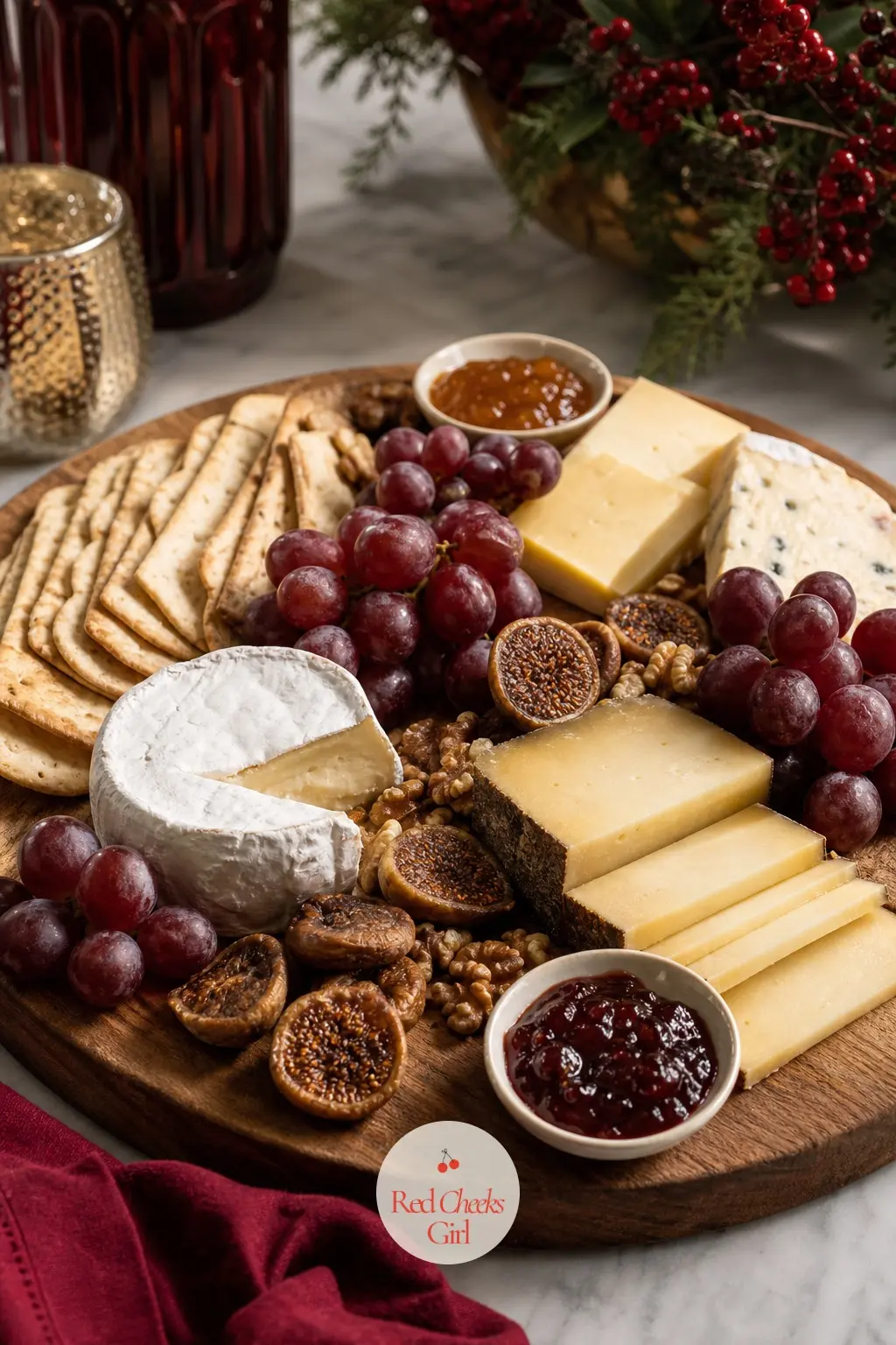 A Cheese Board In Oxblood And Cream — A large wood board carries cream cheeses next to oxblood grapes and dried fig, with small ceramic bowls of preserve