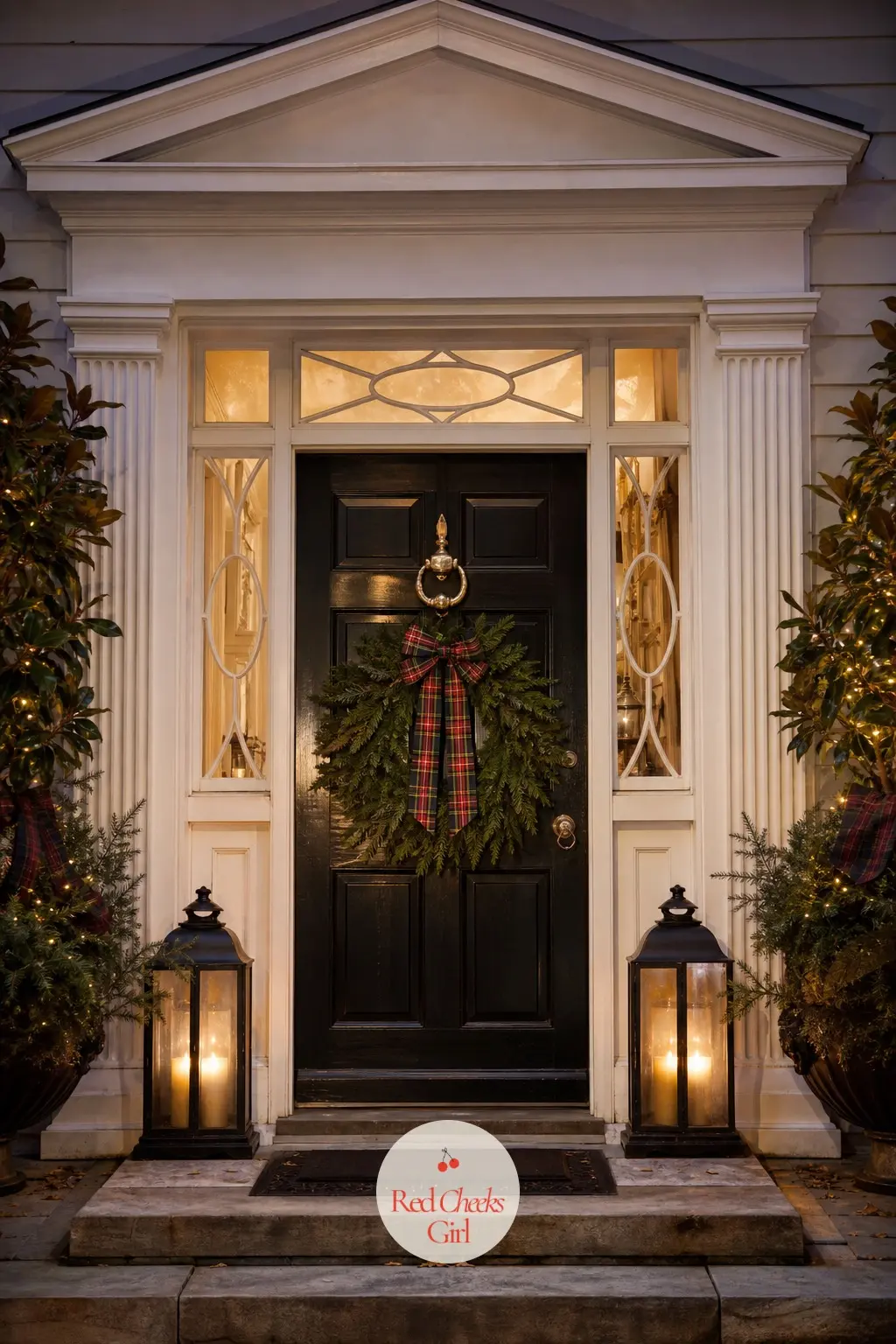 A Front Door That Looks Lived In — A fresh greenery wreath hangs on the front door with one wide tartan bow at its base, a brass door knocker catches the porch