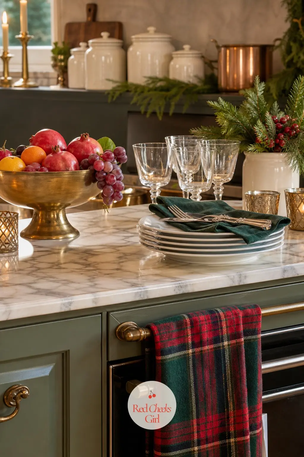 The Kitchen Island Dressed For Company — A brass fruit bowl sits at the end of the island, a stack of cream ceramic canisters lines the counter behind it, and