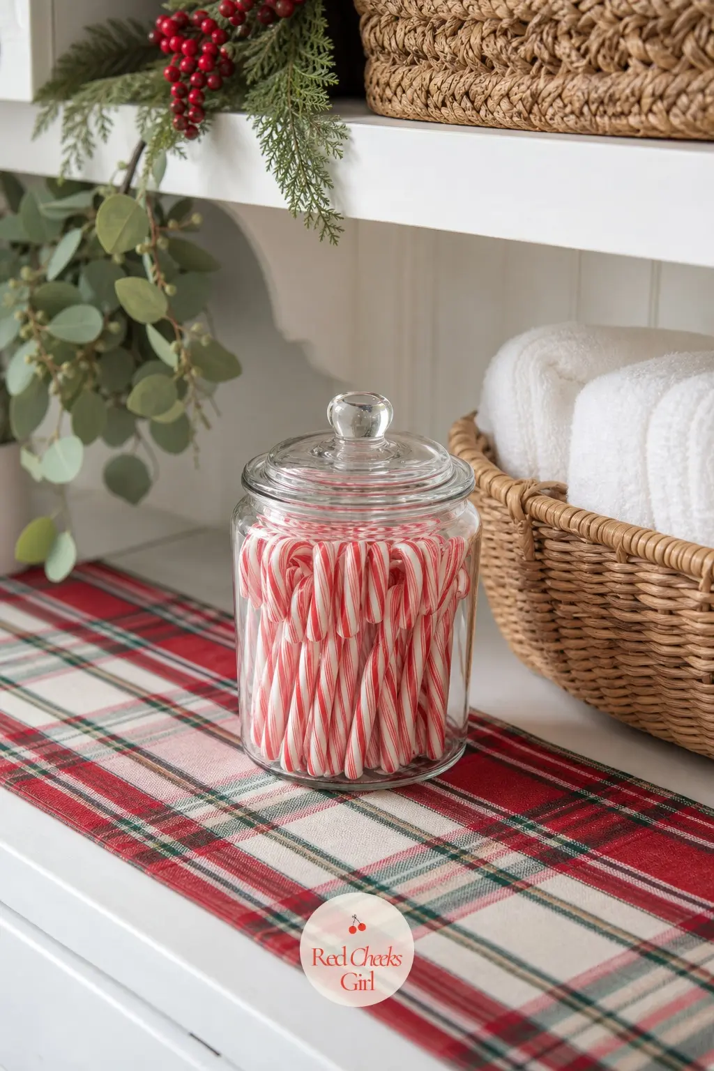The Laundry Nook, A Jar of Candy Canes and a Plaid Runner — Even the laundry room gets a nod: a glass jar of candy canes on the shelf above the machines, and a