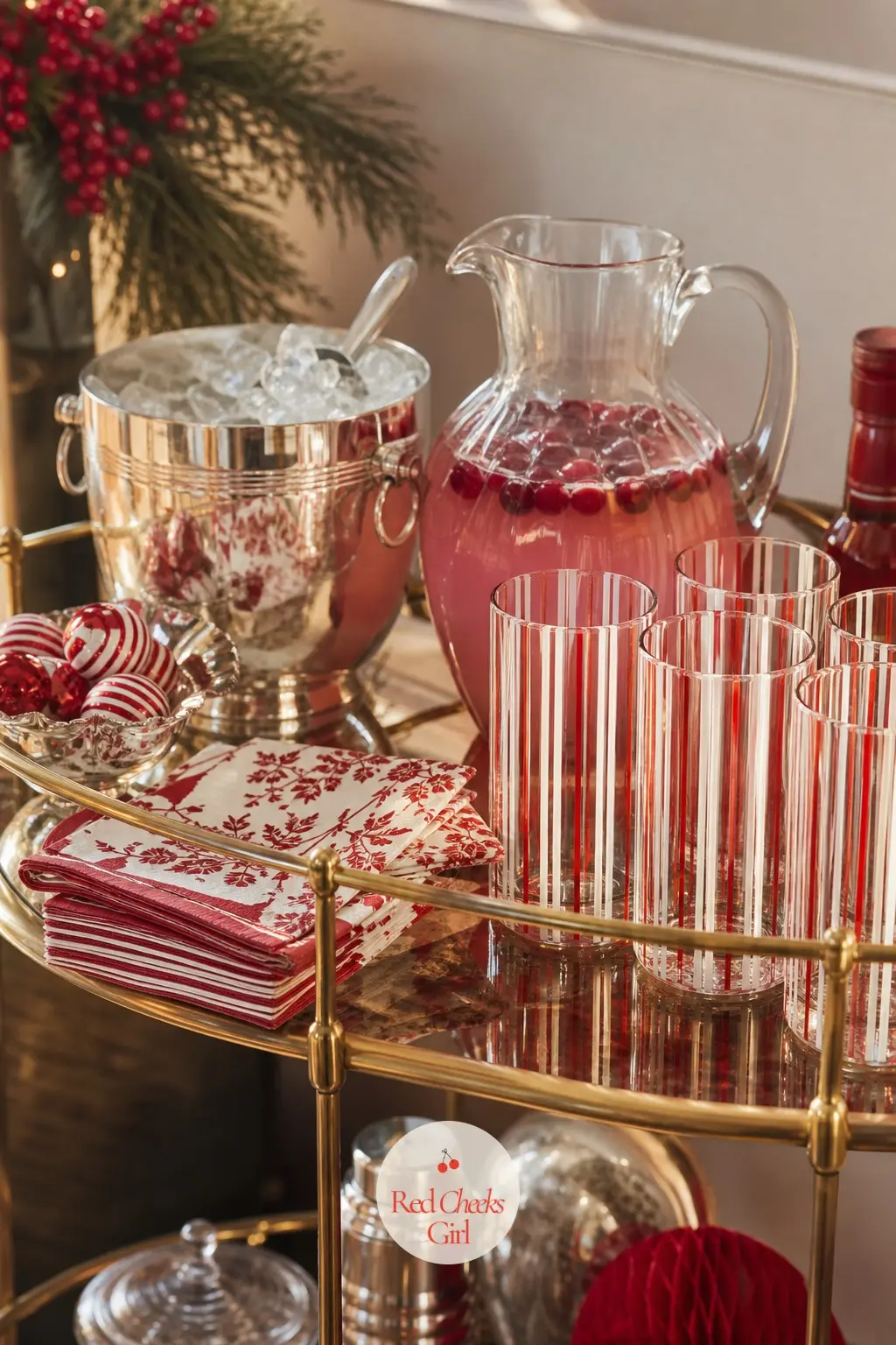 The Drinks Cart — A silver ice bucket sits beside a glass pitcher of peppermint punch, with a short stack of cloth cocktail napkins folded next to a row of