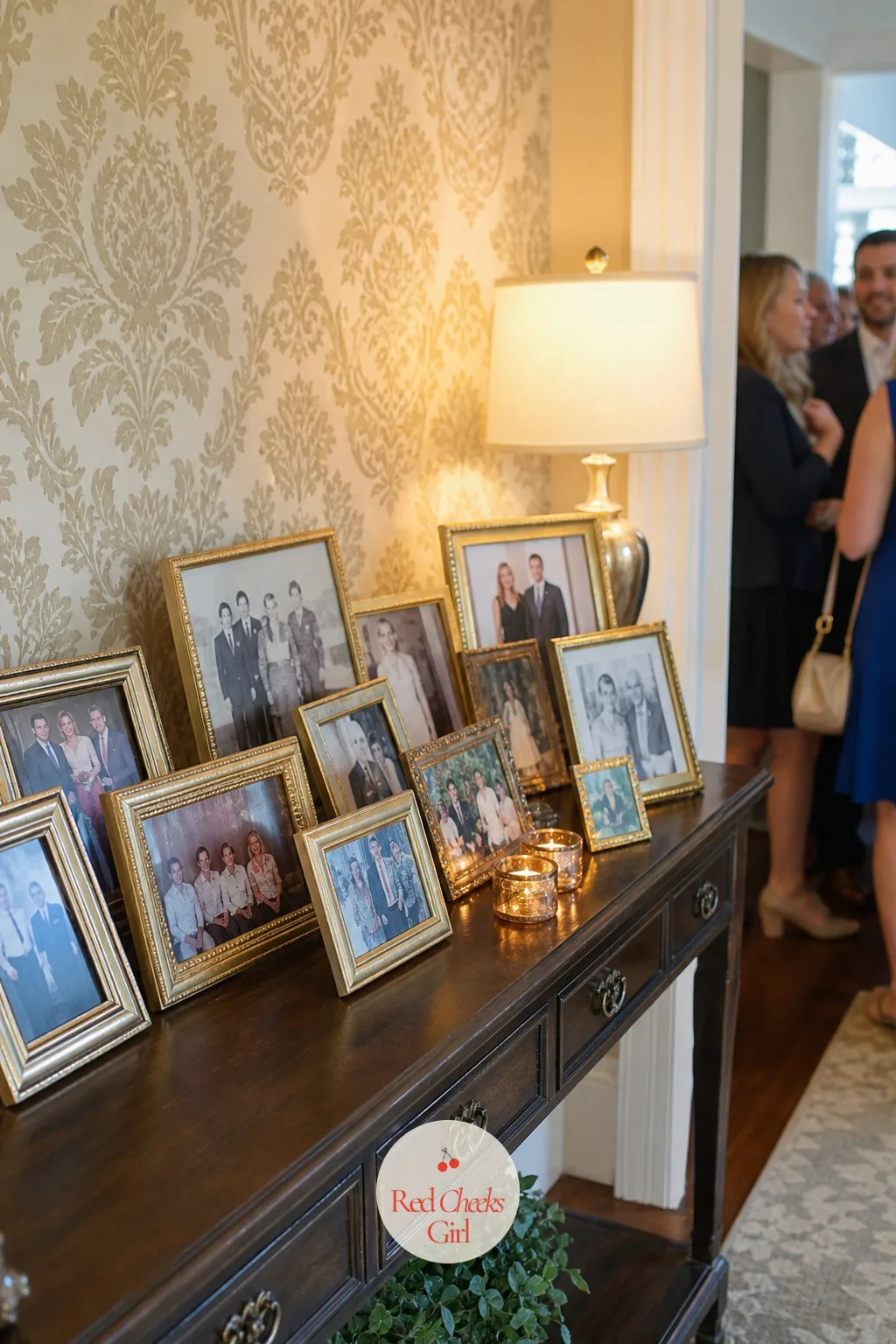 Photo Display of Both Families — A console table near the entrance holding framed photos from both sides, parents as children, grandparents' weddings, old