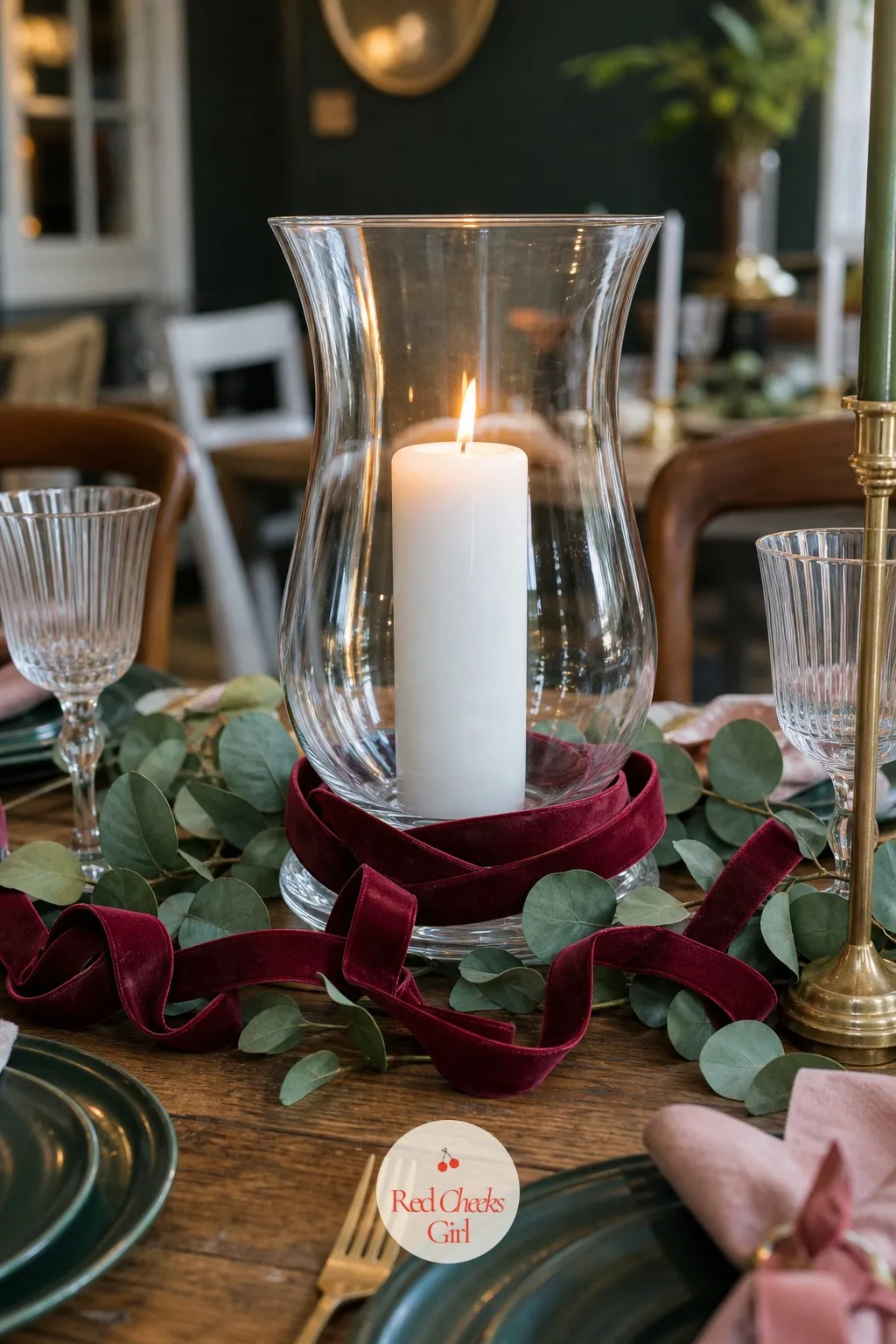 A Short Ribbon Chain Looped Around the Base of a Centrepiece Candle Hurricane — A glass hurricane holding a single pillar candle is lovely on its own and