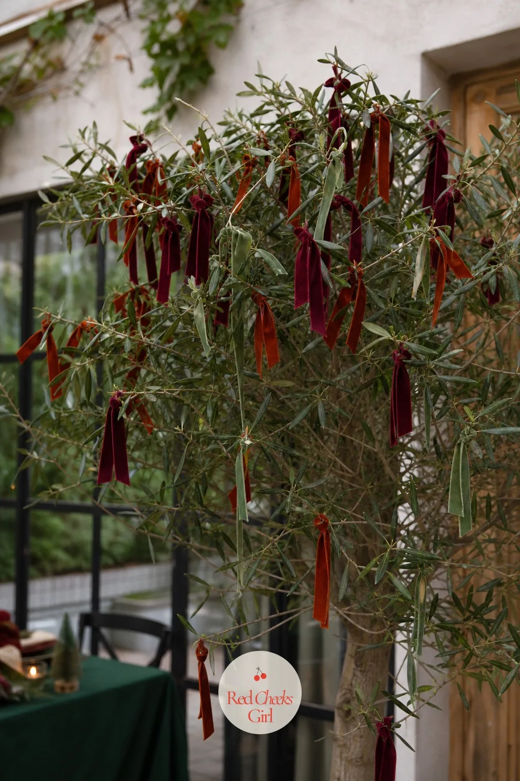 Velvet Ribbon Tails Knotted Directly Onto the Branches of a Live Tree — A tree hung with tails instead of baubles looks undone in the best way, more like
