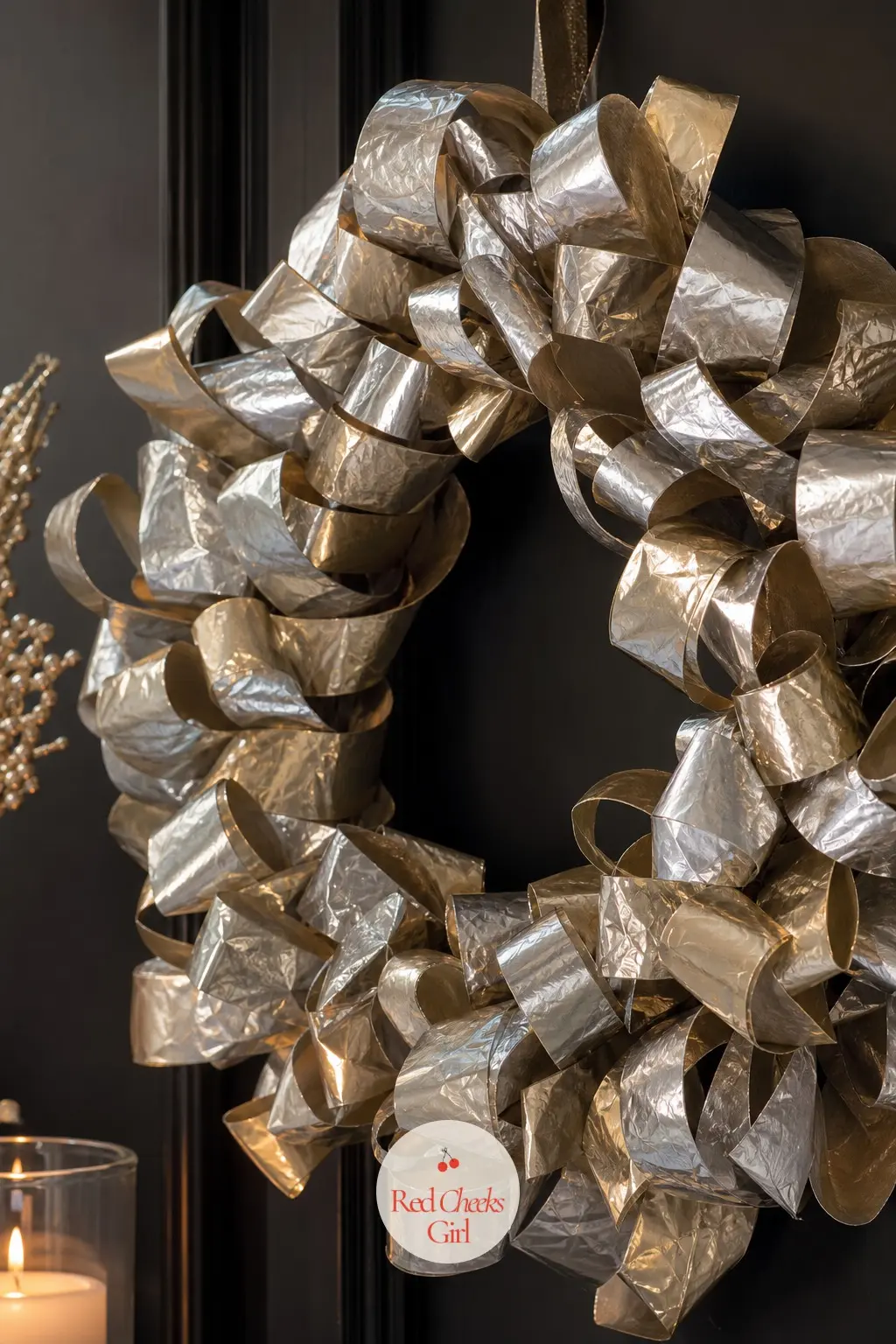 The Metallic Mylar Loop Wreath for the New Year's Countdown — Mylar ribbon holds a stiff, almost crinkled loop that no fabric ribbon can manage, so this wreath