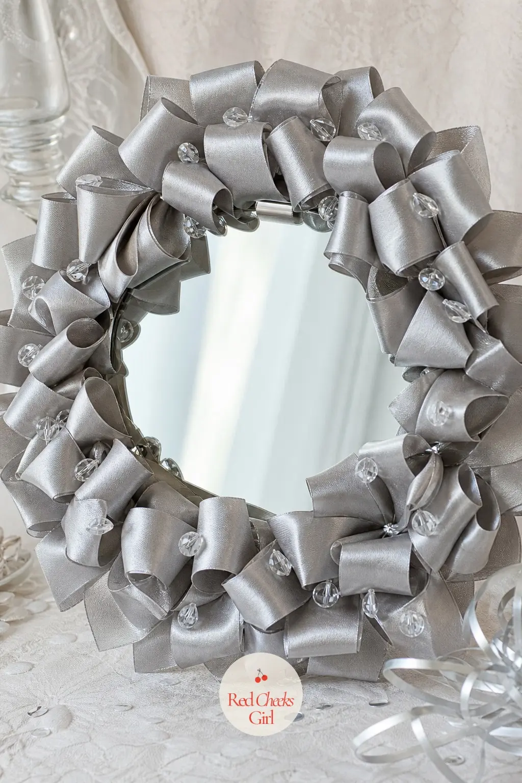 The Silver Satin Loop and Crystal Bead Wreath for the Cocktail Mirror — Hung on a mirror rather than a door, this wreath has to look finished from both the