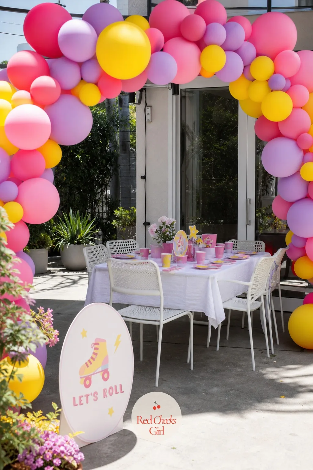 Patio Under a Rainbow Balloon Arch — Walk onto the patio and this is the first thing she sees: a wide arch of balloons in pink, lilac and sunshine yellow