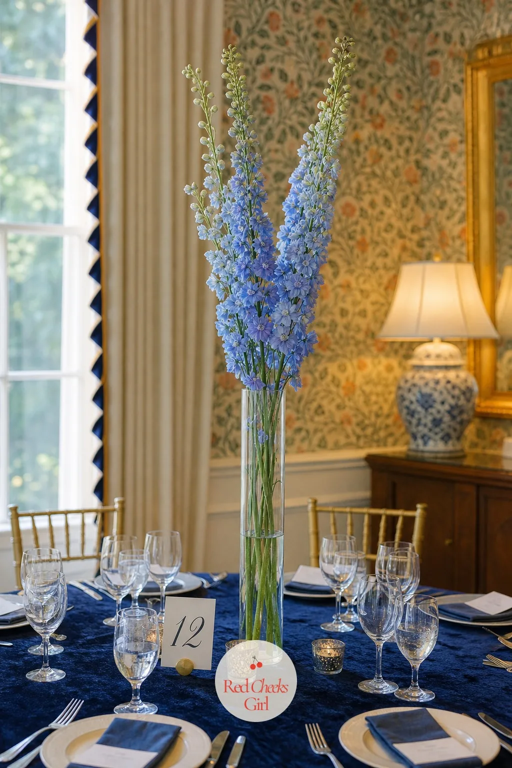 Slim Glass Cylinder With Towering Delphinium — No wide floral head here, just a narrow glass cylinder vase with a handful of delphinium or larkspur stems