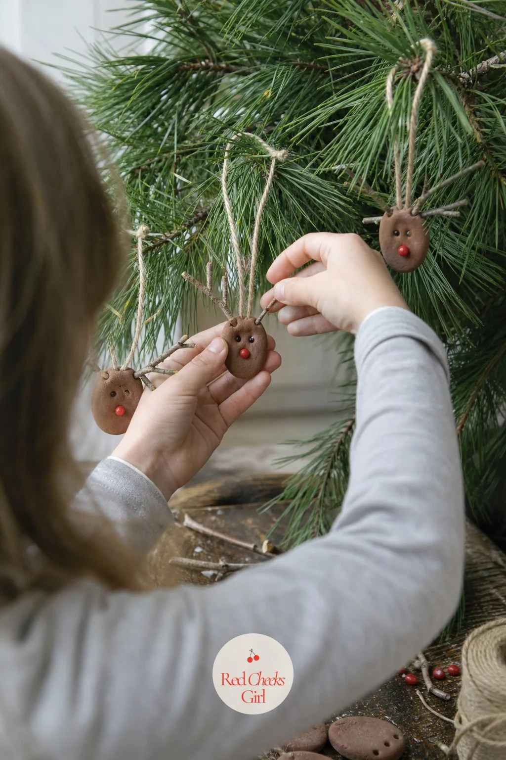 Fingerprint Reindeer Ornaments — A brown thumbprint for the body, two thin dough sticks pressed in for antlers before baking, a single red dot for the nose.