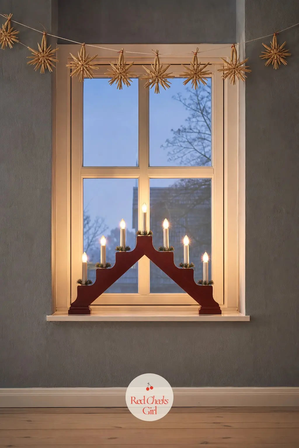 The Advent Candle Arch, Switched On at Dusk — The Swedish candle arch sits in a window recess rather than loud on a wall, its small bulbs the only warm light