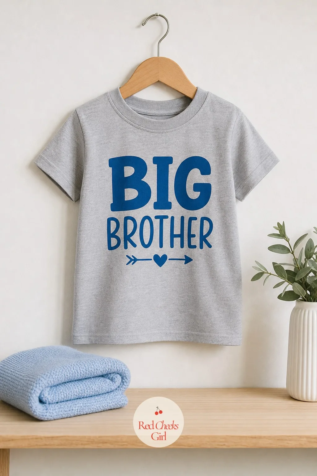 The Big Brother or Big Sister Shirt — She shows up in a plain zip-up hoodie, and when she unzips it in front of everyone, the shirt underneath already says it