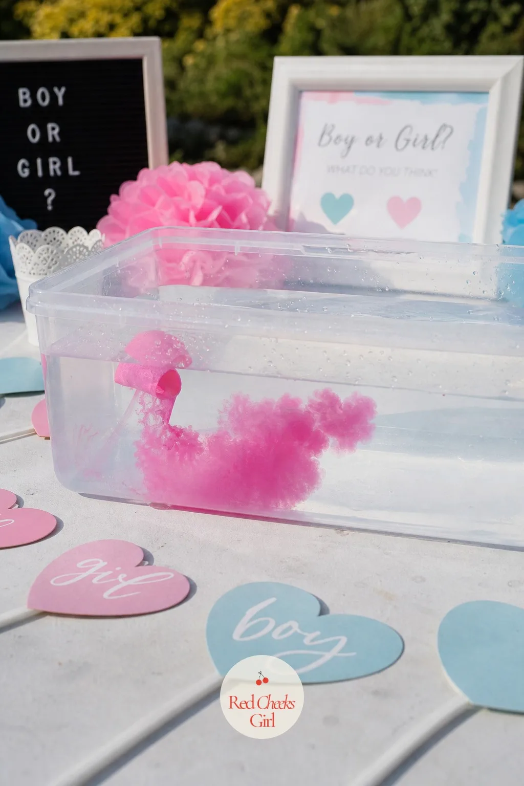 The Color-Burst Water Balloon — She draws her arm back and lets a single water balloon fly into a tub of clear water, and the splash itself becomes the reveal