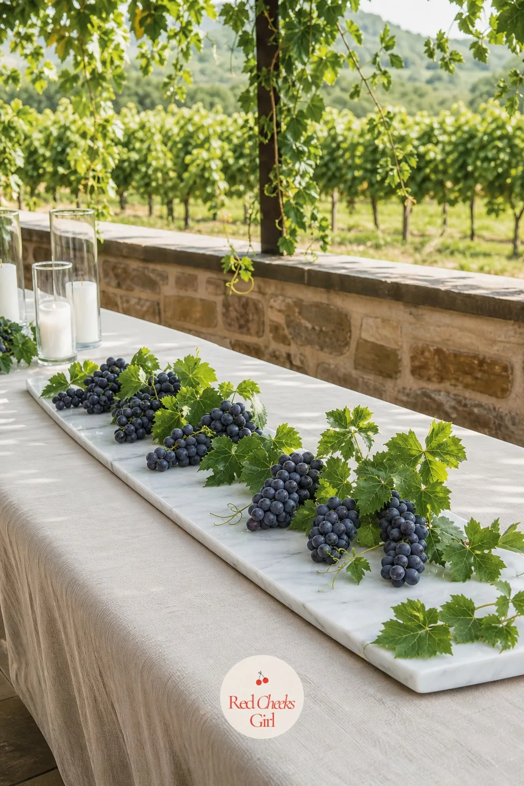 Grape Clusters and Greenery on a Marble Board — A vineyard or wine-country reception wants a centerpiece that nods to the setting without feeling like a