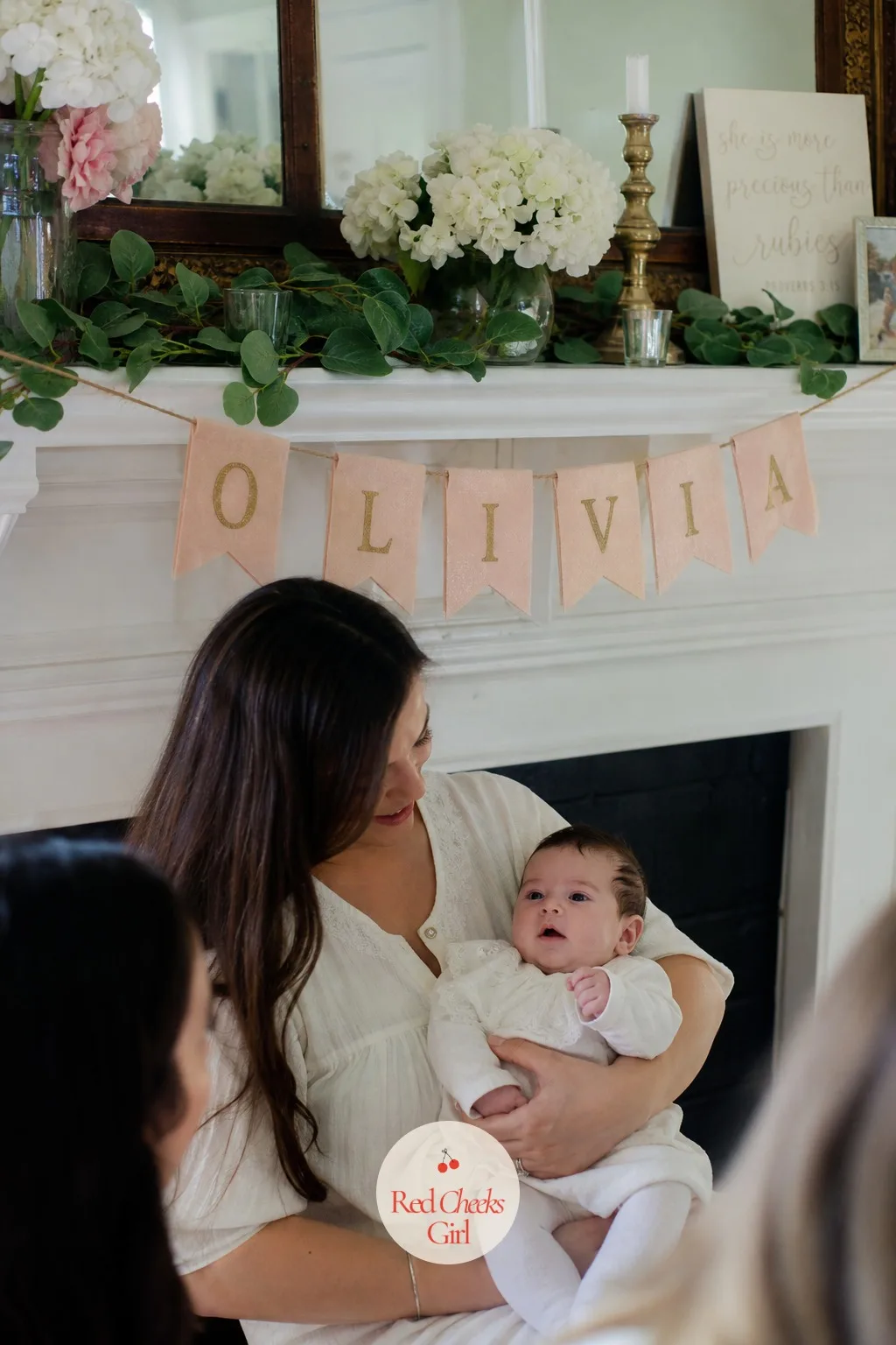 Baby's Name Banner — Every room needs one spot where cameras naturally point, and a name spelled out on the wall gives guests that spot without anyone staging