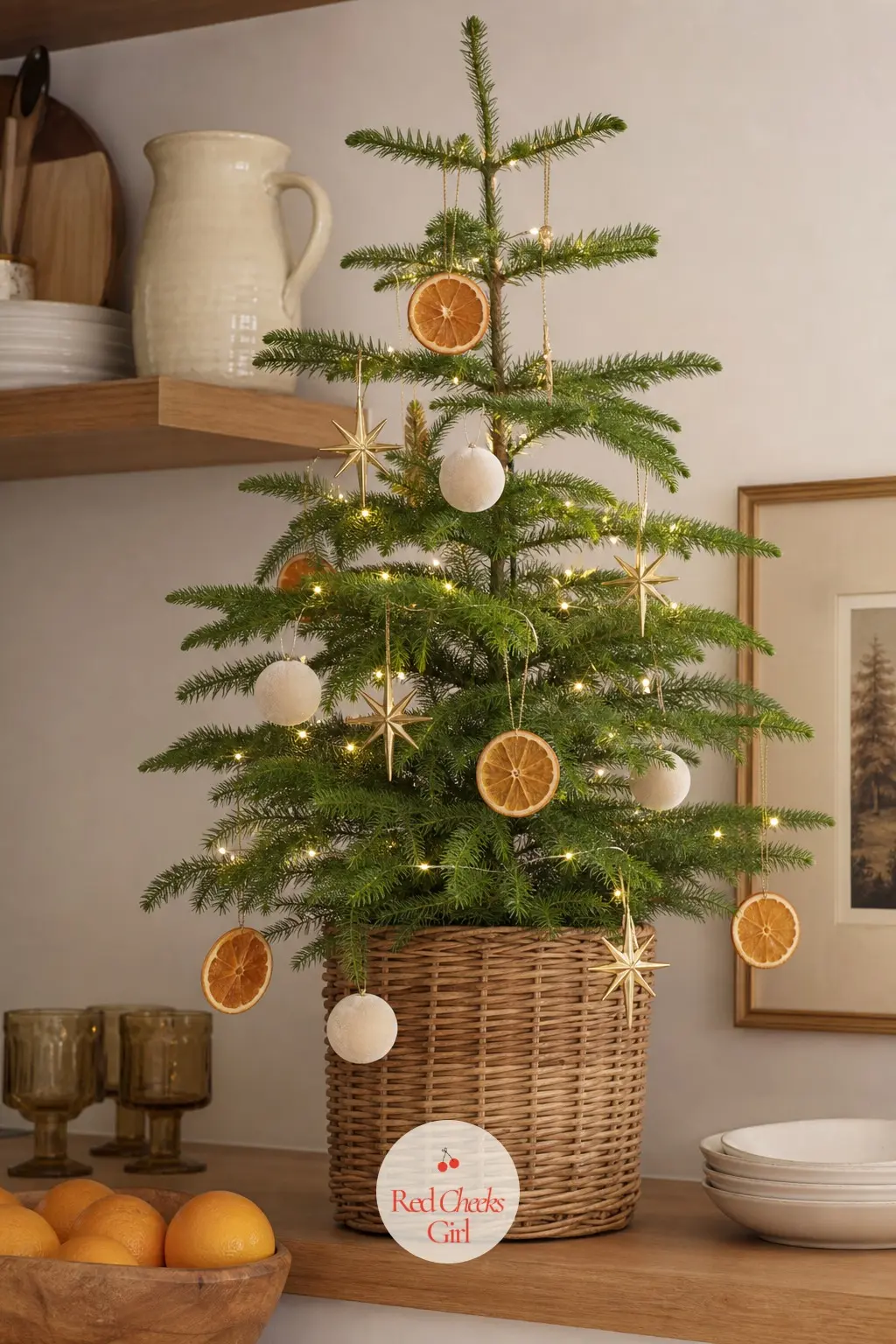 A Slim Potted Norfolk Pine in Citrus and Gold — A living Norfolk Island pine, naturally tiered and narrow without any pruning at all, which makes it one of the