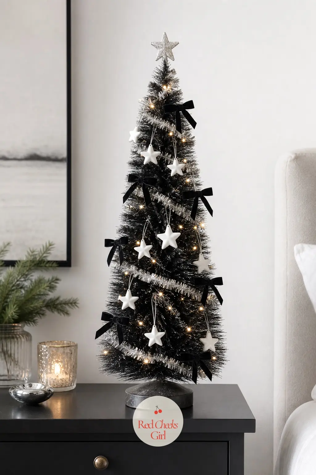 A Black Mini Tree on the Nightstand — An artificial black bottle brush style tree, small enough to sit entirely on a nightstand without a stand reaching the