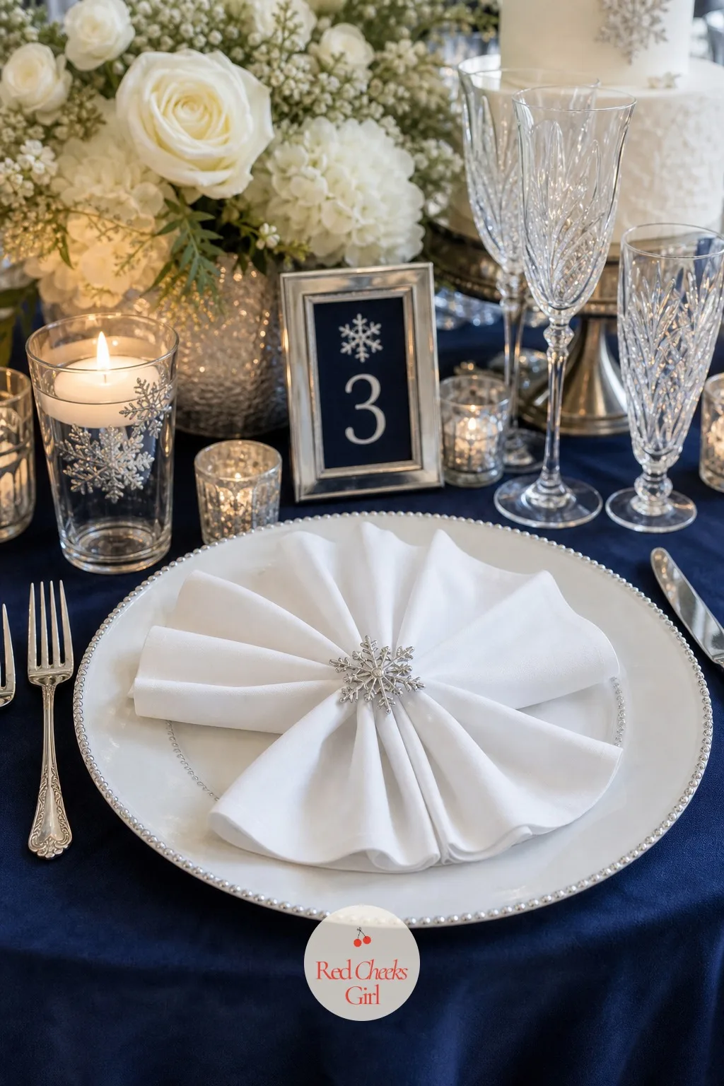 Snowflake Napkin Fold With a Silver Ring — A folded napkin either looks like nobody tried or like somebody did, and this one takes under a minute to land on