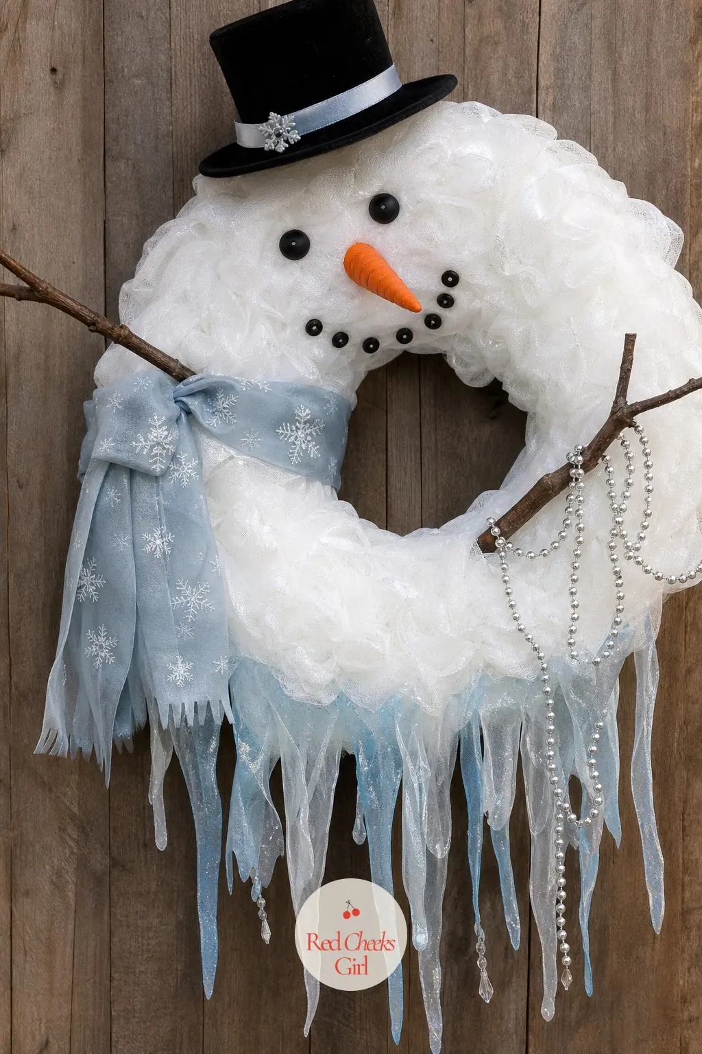 The Melting Snowman Wreath — Build the body slightly off-center on purpose, letting one side sag lower than the other, then hang pale blue ribbon lengths from