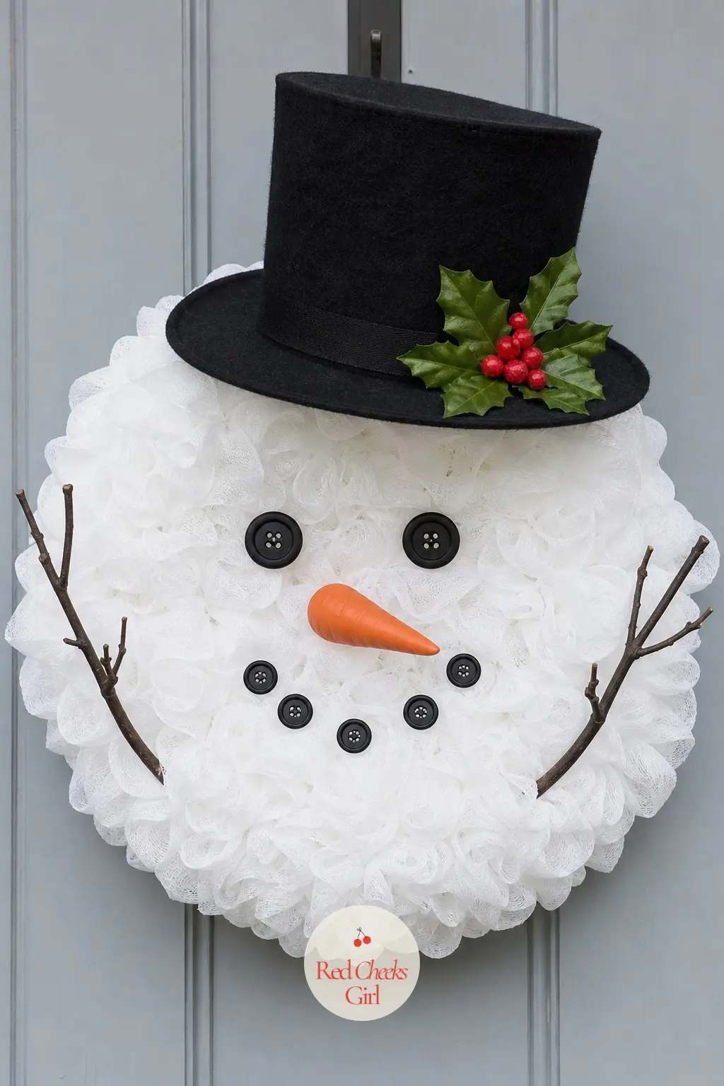 The Top Hat and Holly Sprig Snowman Wreath — This is the dressed-up cousin of the group: a crisp black felt top hat tipped at an angle, with a sprig of deep