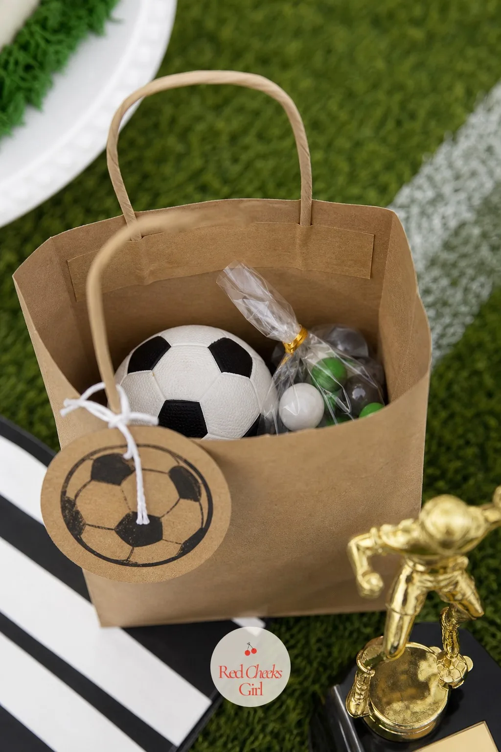 Mini Soccer Ball Favor Bags — The goody bag is the last thing a guest touches on the way out, so it is worth matching the rest of the table instead of filling