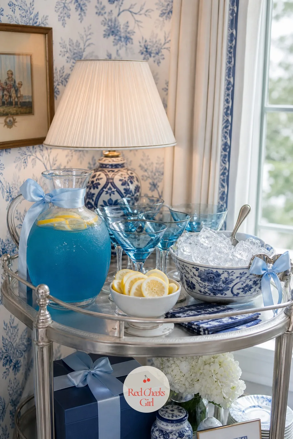 Blue Cocktails and Mocktails — Set on a side table or small cart rather than the main spread, a drinks station pours the one signature colour of the whole