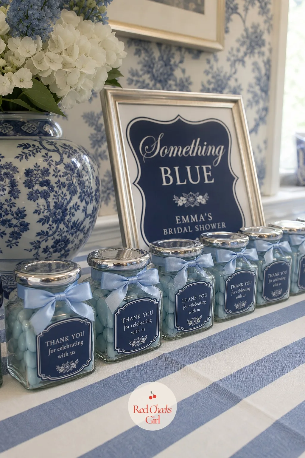 Blue Favors — Laid out along the favour table in a neat row, each guest's take-home gift wears the same navy and powder blue as everything else: a small bottle