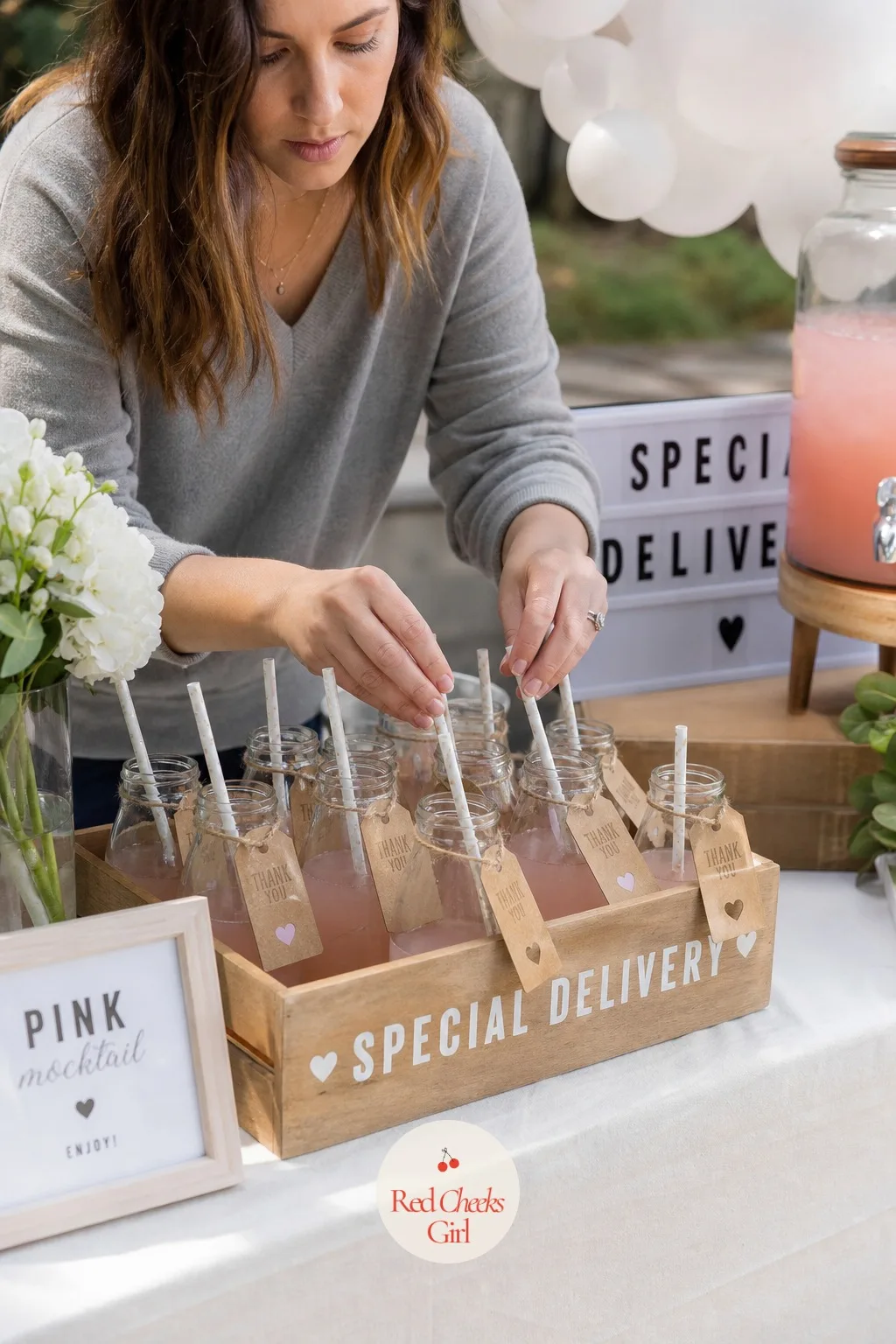 Milk Bottle Crate Mocktail Station — A drink station needs its own small moment, and small glass milk bottles filled with a pale pink mocktail, set upright in