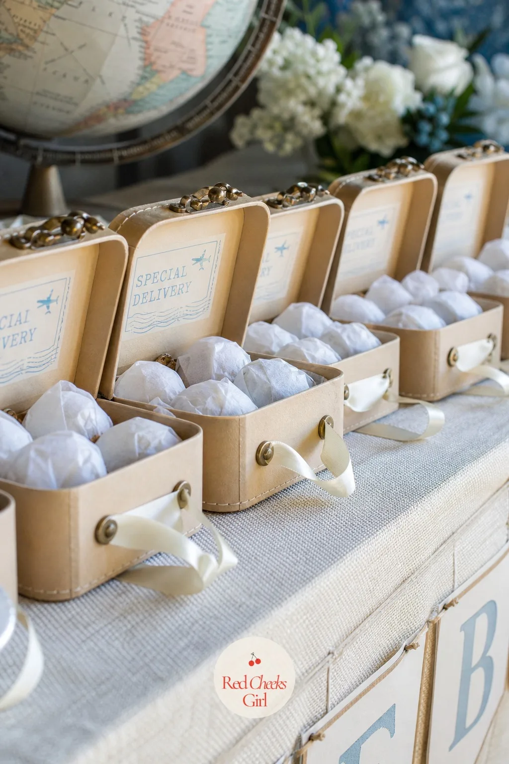 Mini Cardboard Suitcase Favor Boxes — For the travel take, the favor is the suitcase itself. Special delivery baby shower theme