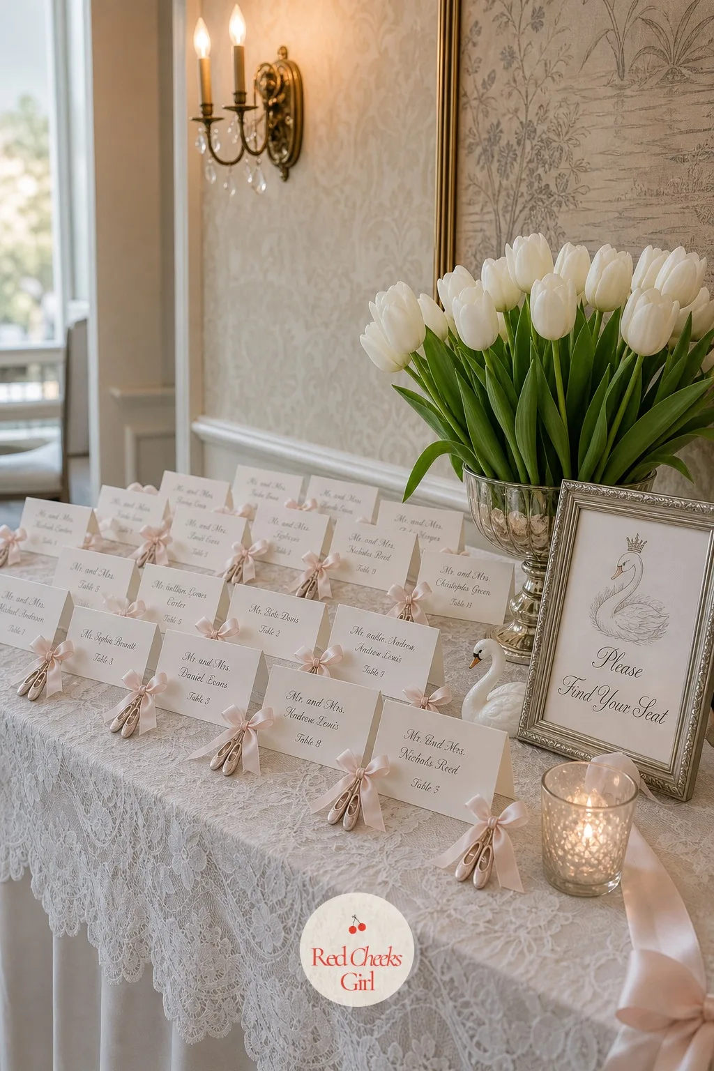 Pointe-Shoe Place Cards at the Escort Table — Guests cluster around the seating chart the moment they walk in, and a wall of plain tented cards gives them