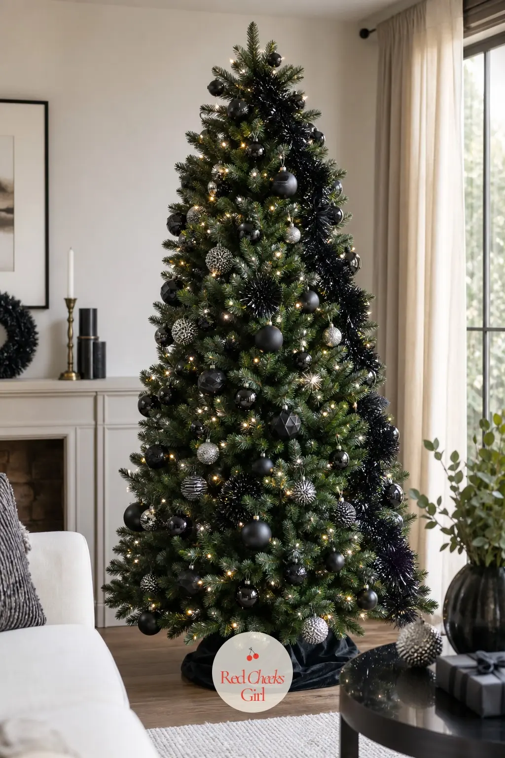 The Black Tinsel Edge Tree — A full artificial tree, floor to ceiling, wearing black tinsel garland instead of the expected silver or gold, with silver-studded