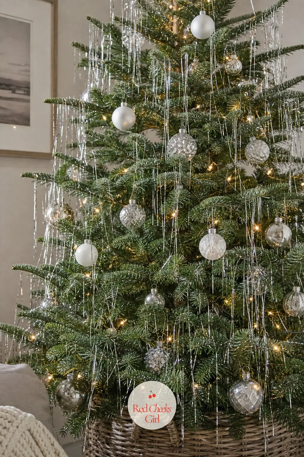 The Silver Icicle Fir — A real, full fir dressed the old way: loose silver icicle tinsel draped over the branches rather than wound tight, so it moves when the