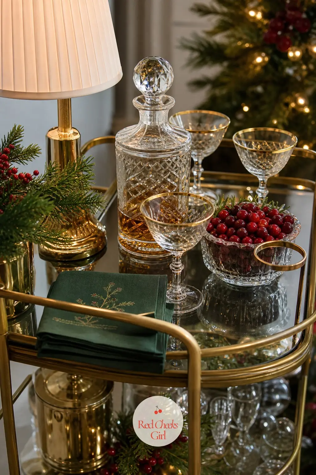 A Bar Cart Dressed for the Adults — A brass bar cart holding gold-rimmed glassware and a decanter set gives the grown-ups their own corner, away from the cocoa