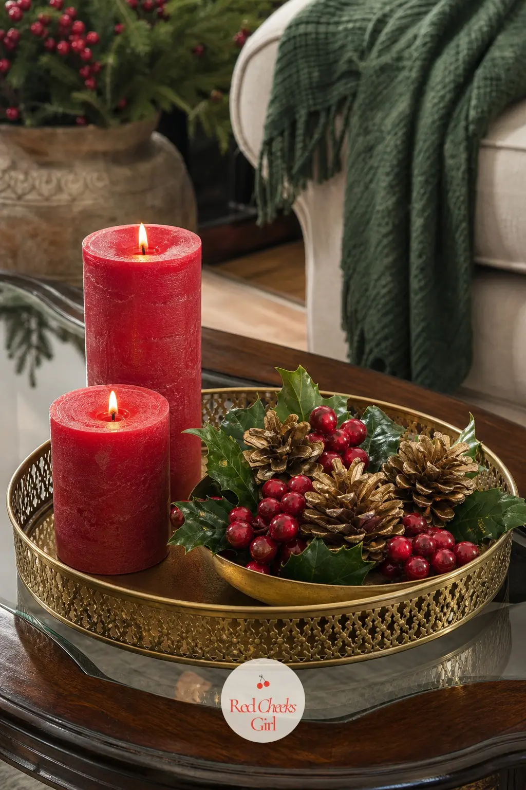 The Coffee Table Set for an Evening In — A gold tray anchors the coffee table, holding two red pillar candles and a shallow bowl of holly berries and gilded