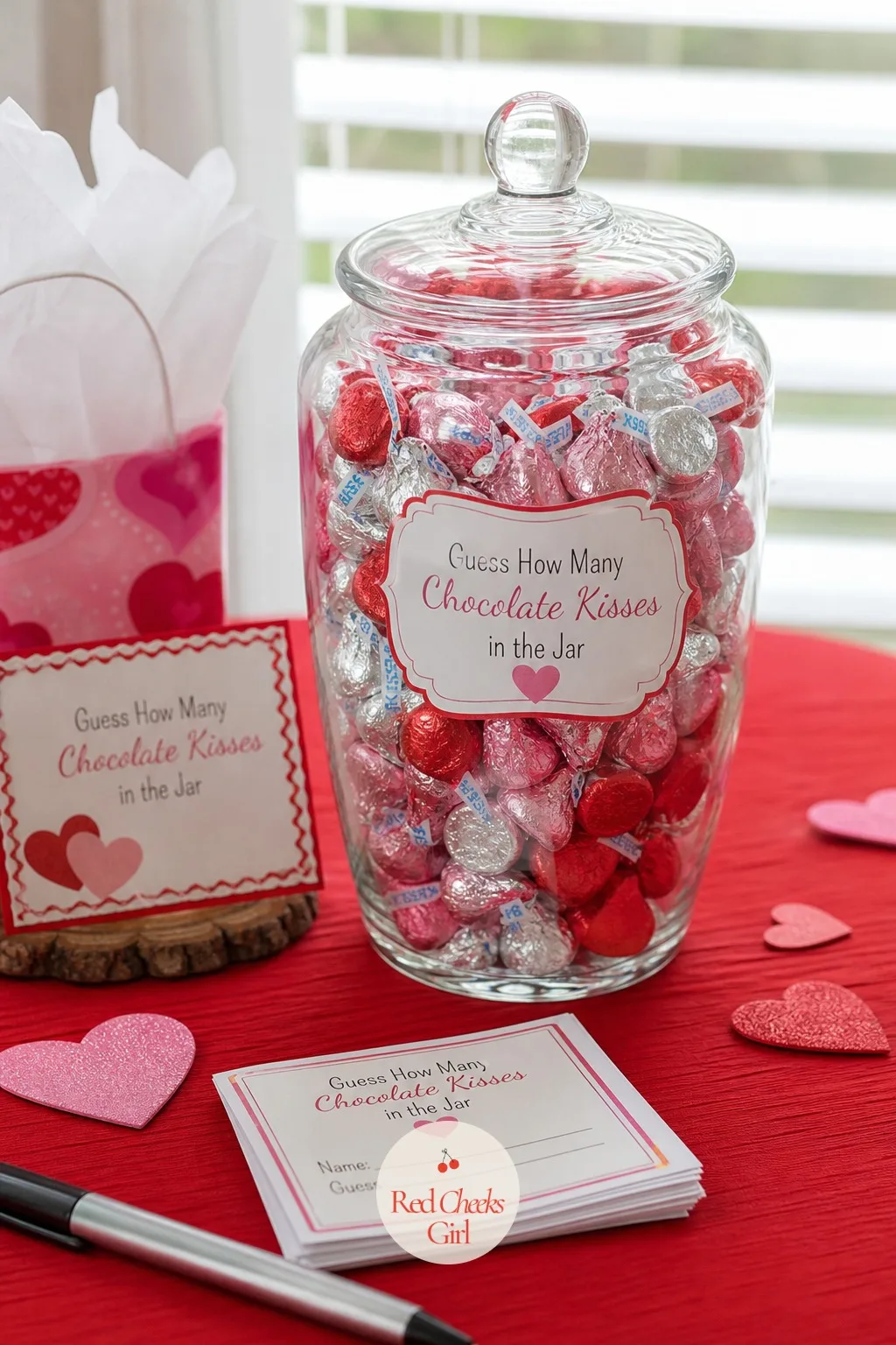 Guess How Many Chocolate Kisses in the Jar — Fill a clear glass jar with foil-wrapped chocolate kisses and set it out with a stack of small guess cards and a
