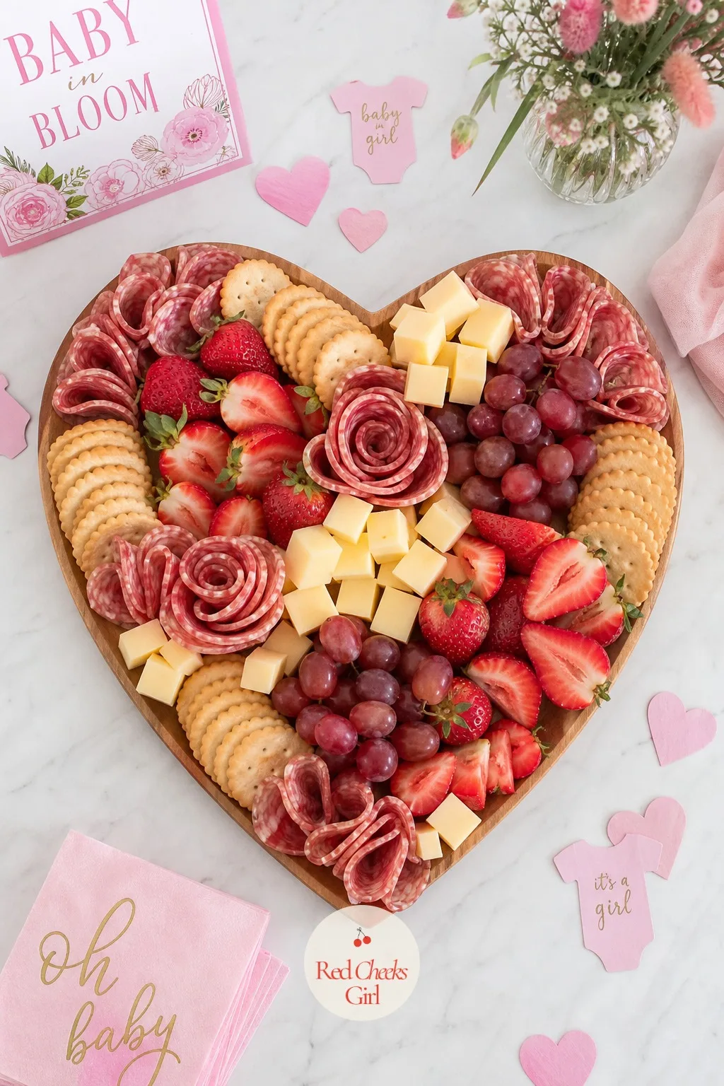 Heart Charcuterie Board — Arrange a wooden board into the outline of a heart using folded salami roses, cubed cheddar and brie, red grapes and strawberries