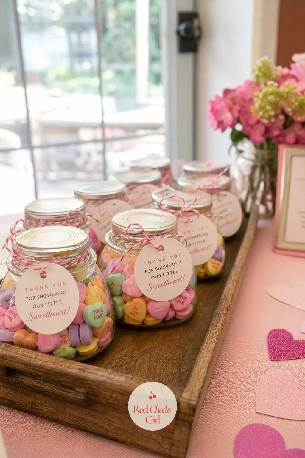 Mini Conversation Heart Candy Jar Favor — Small glass jars filled with a scoop of conversation heart candies, a round tag tied on with twine reading 'thanks