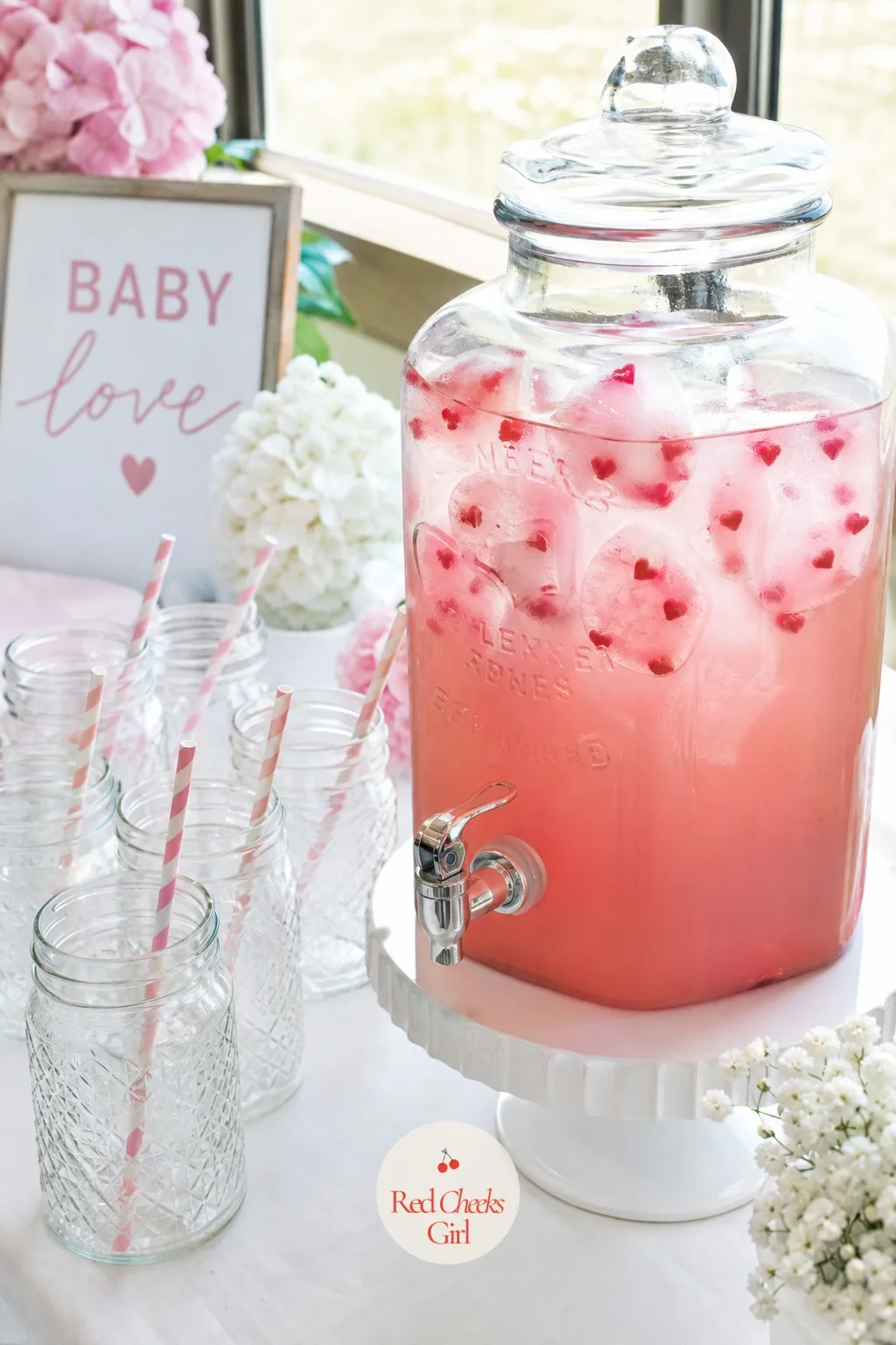 Pink Lemonade with Heart Ice Cubes — A drink dispenser of pink lemonade looks like nothing special until the ice cubes catch the eye, each one frozen with a