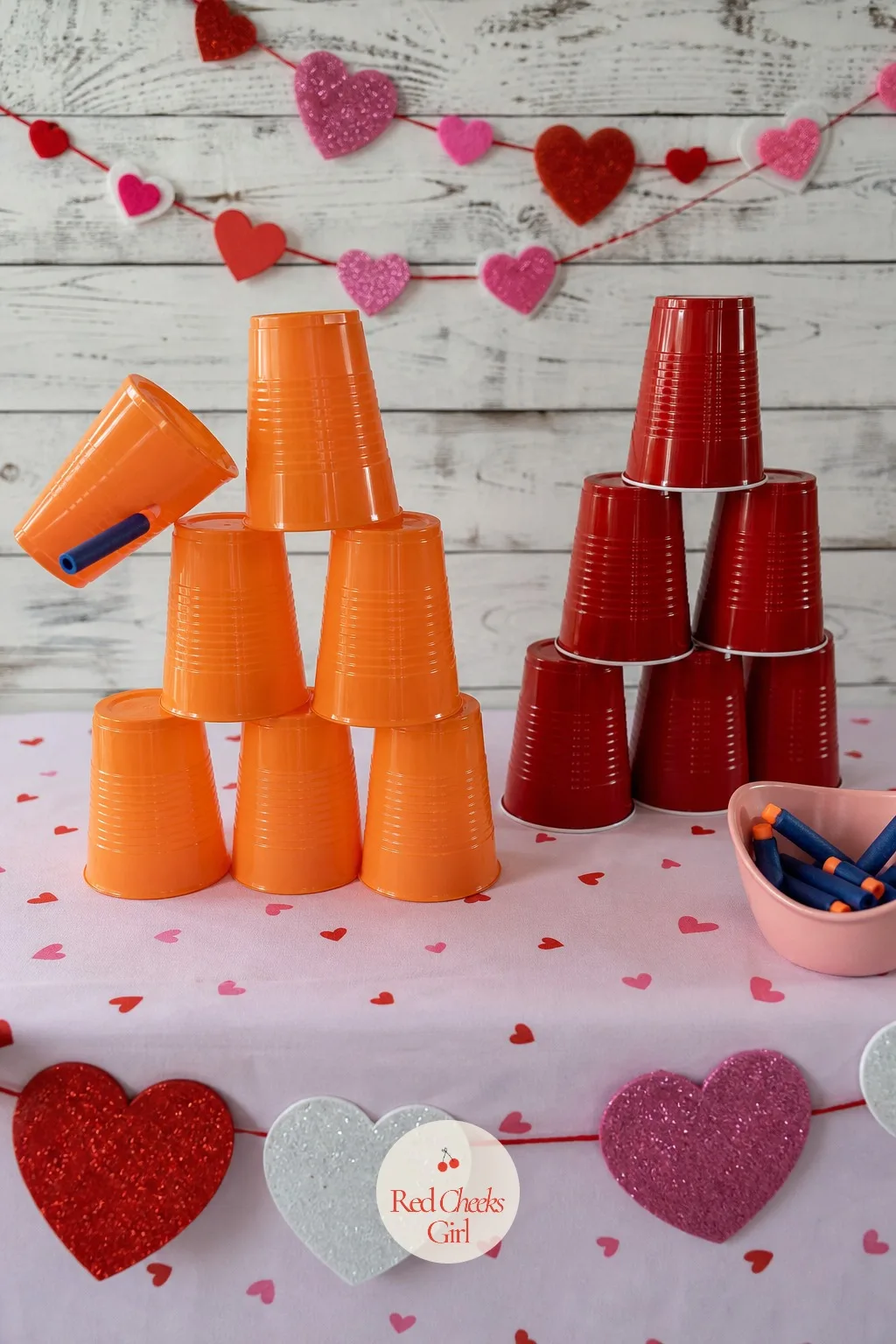 Cupid's Castle — A tower of plastic cups looks sturdy until a foam dart finds the gap, and the slow-motion collapse is the best part of the whole game.