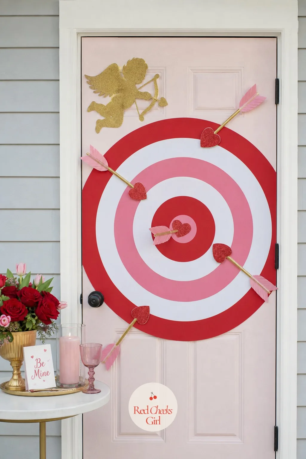 Cupid's Target Door — A circular target in concentric red, white and pink rings turns the door into Cupid's actual aim. Valentine door decorations