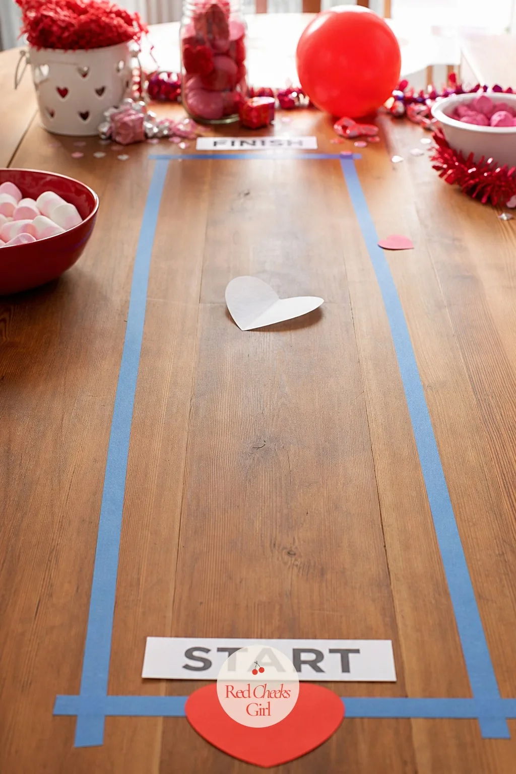 Gone with the Wind — Watching someone go red in the face trying to blow a paper heart in a straight line is funnier than it should be, and it needs nothing
