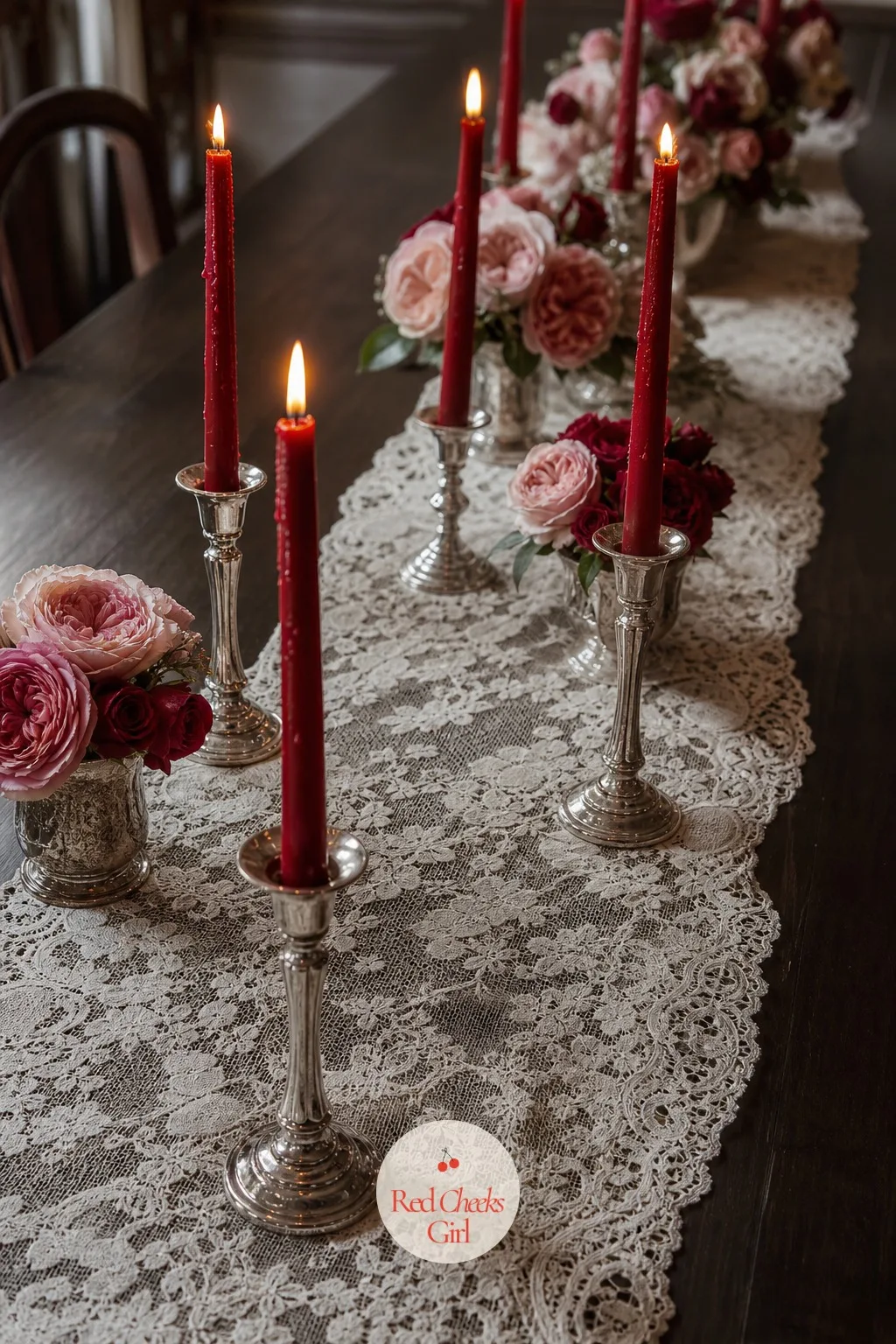 A Lace Runner With Red Taper Candles — This is the piece that sets the tone before anyone sits down. Valentine table decorations