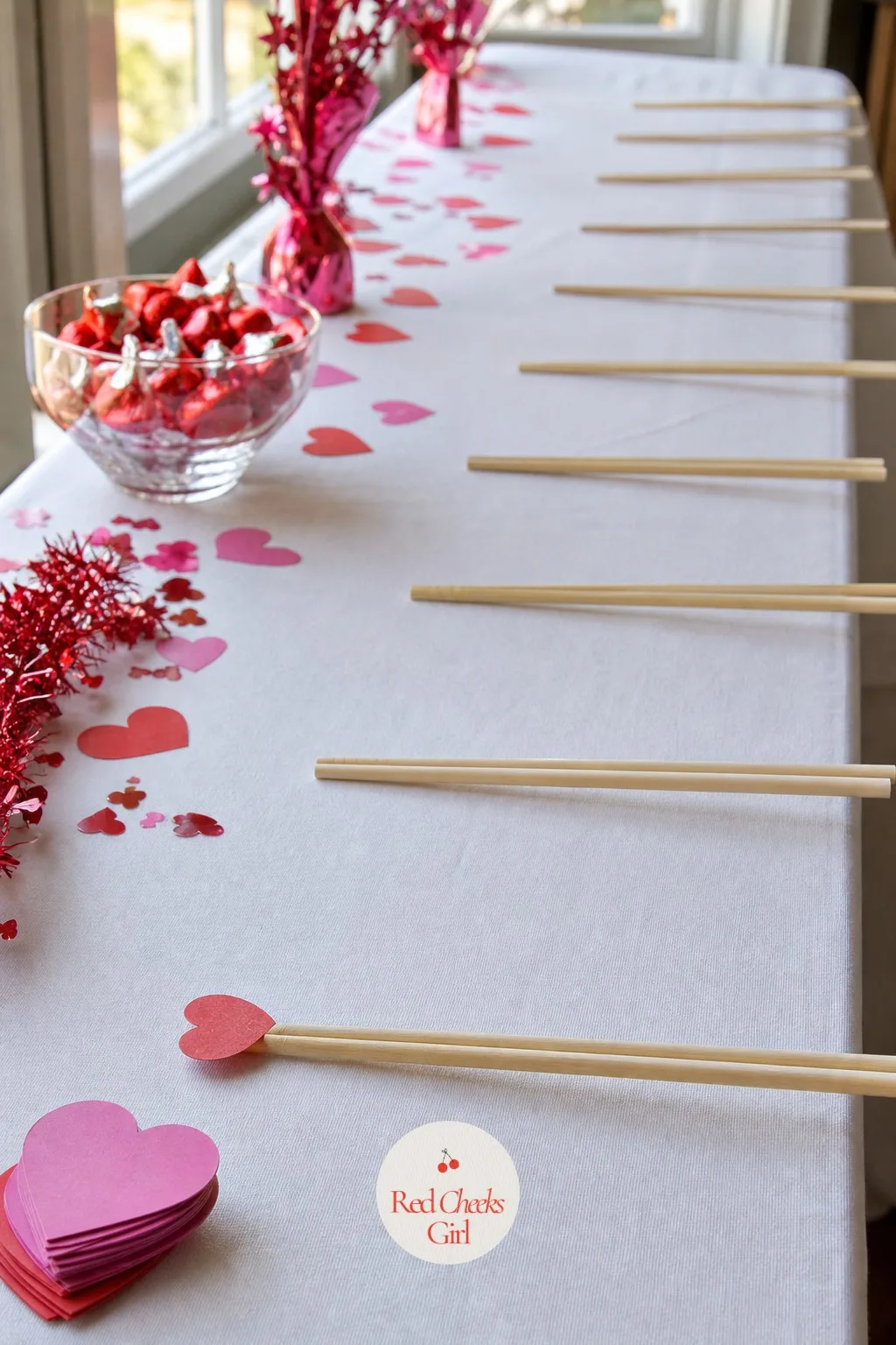 Chopstick Heart Relay Chain — Line everyone up, hand each person one chopstick, and pass a small paper heart down the line stuck only on the tip, no hands