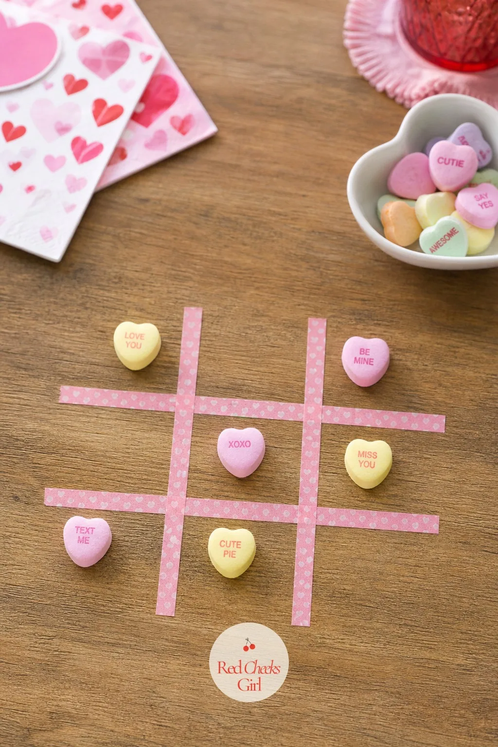 Conversation Heart Tic-Tac-Toe — Washi tape makes a grid on any table in under a minute, and conversation hearts stand in for X's and O's: pink hearts for one